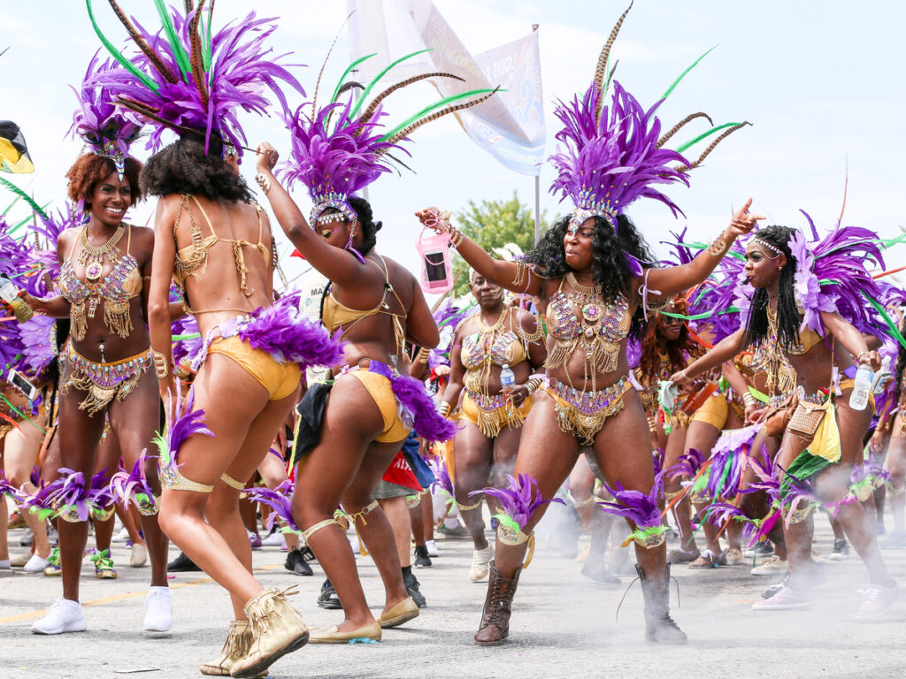 Women dancing in parade at Toronto Caribbean Carnival or Caribana
